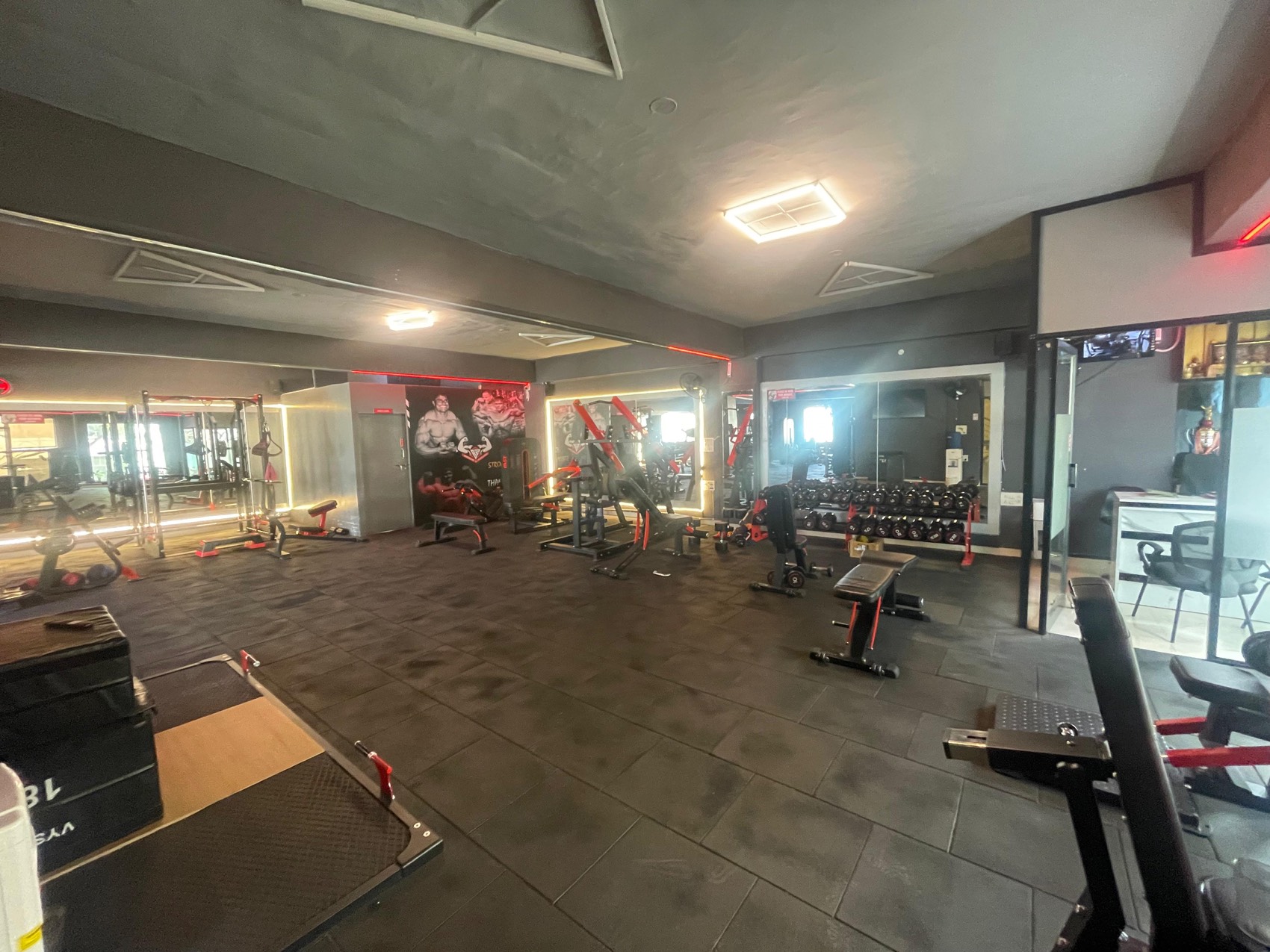 Mirrored training floor with dumbbell rack at BurnZone Rajajinagar